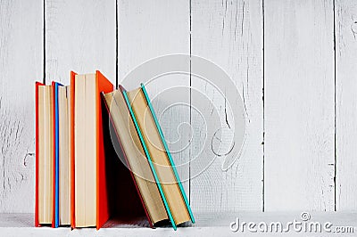 Books on a wooden shelf.