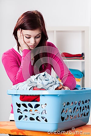 Bored woman and box with laundry