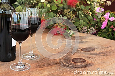 Bottle & Glasses of Red Wine on Outdoor Table