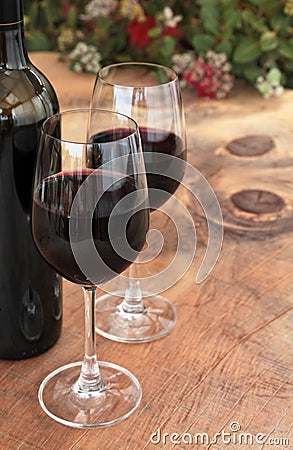 Bottle & Glasses of Red Wine on Outdoor Table