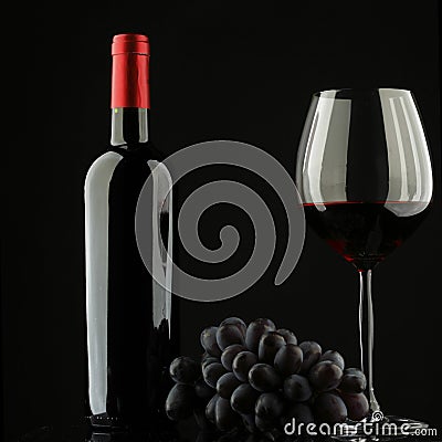 Bottle with red wine and grapes