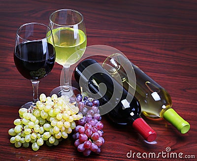 Bottles of Red and White Wine with Fresh Grapes. G