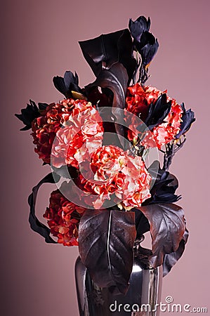 Bouquet of red hydrangea and dark blue magnolia in a vase