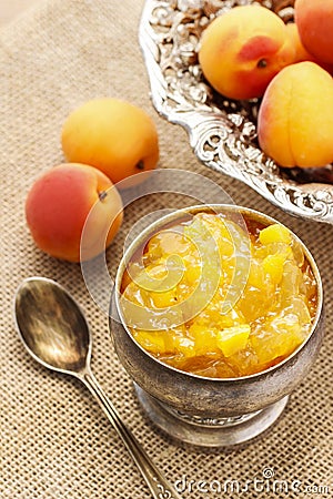 Bowl of apricot jam and ripe apricots in the background