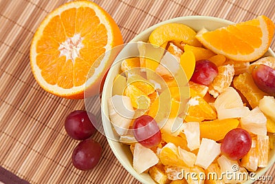 Bowl with fruit salad with half of orange