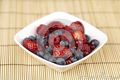 Bowl of fruit salad on a straw mat