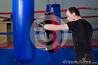Boxer punching a sand bag with back hand