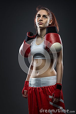 Boxing woman standing in dress boxing , boxing gloves on his shoulder