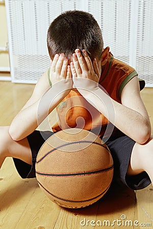 Boy with basketball on floor closeup