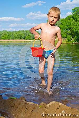 Boy with a bucket of water