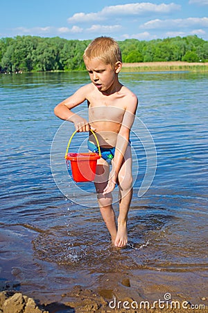 Boy with a bucket of water