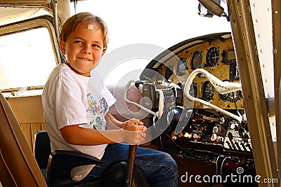 Boy in cockpit of private airplane