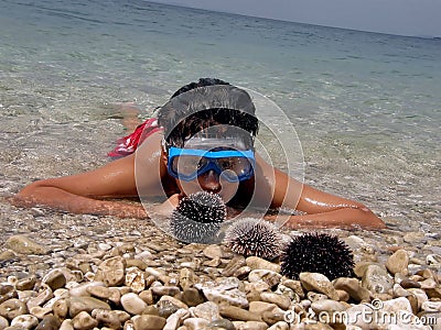 Boy, diving mask, sea urchins