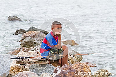 Boy fishing at thai sea