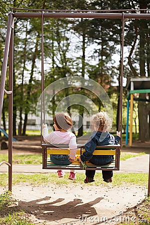 Boy and girl on the swings