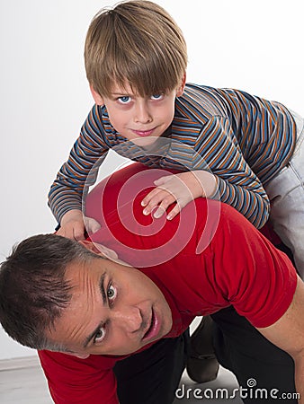 A boy on his fathers back, parenting can be diffic