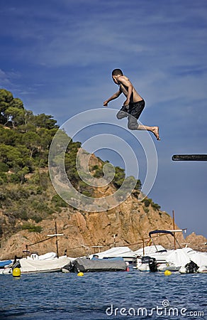 Boy jumping off diving board