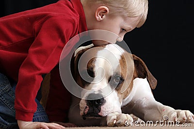 Boy kissing dog