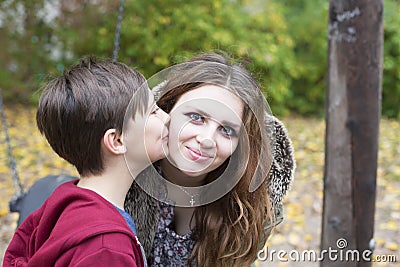 Boy kissing teenage girl on her cheek