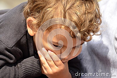 Boy making a funny face with hand