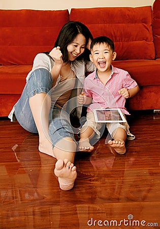 Boy and mother playing games with tablet