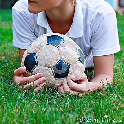 Boy with old soccer ball