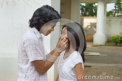 Boy pinching girl s cheeks