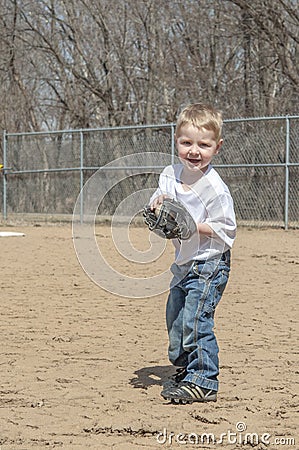 Young boy playing catch with ball and glove