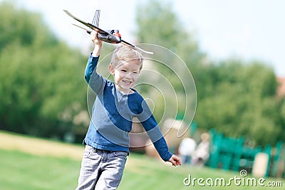 Boy playing his toy plane