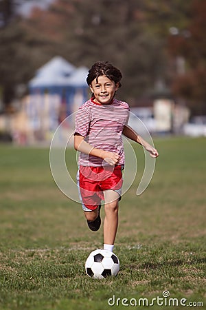 Boy playing soccer in the park