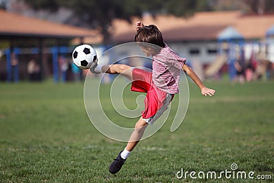 Boy playing soccer in the park