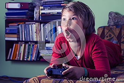 Boy playing a video game console.