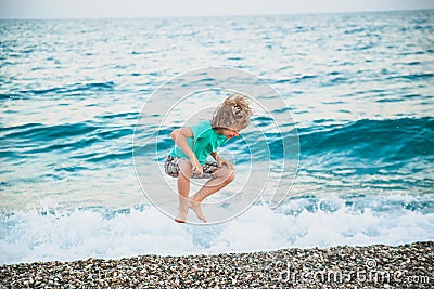 A boy plays with the sea waves