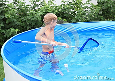 Boy in pool cleaning water