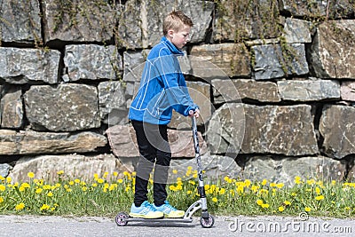 Boy riding a scooter