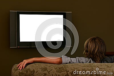 Boy sitting on couch watching widescreen television
