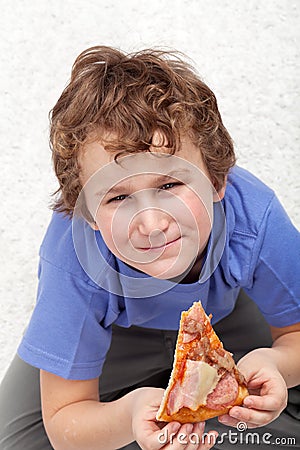 Boy with a slice of pizza