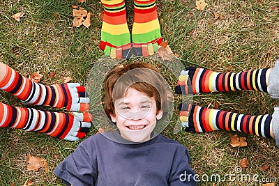 Boy Smiling Surrounded by Toe Socks