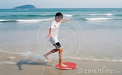 Boy Surfing through waves