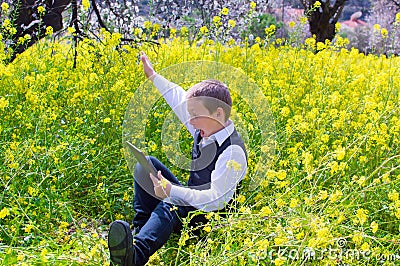 Boy with tablet pc outdoors