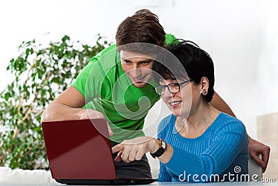 Boy teaching woman computer science