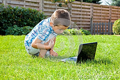 Boy using laptop outdoor