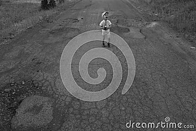 Boy walking on the cracked road