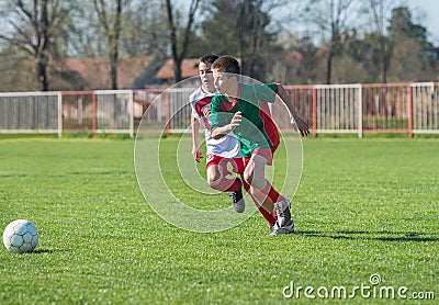 Boys kicking football