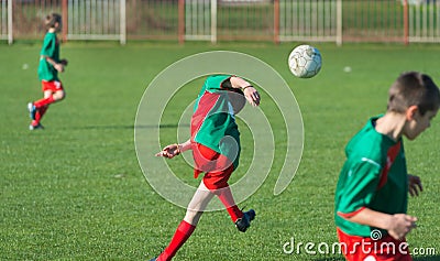 Boys kicking football