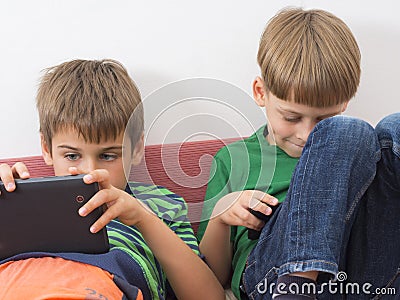 Boys playing video games on tablet computers