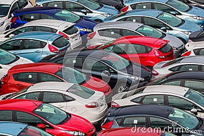 Brand new motor vehicles crowed in a parking lot