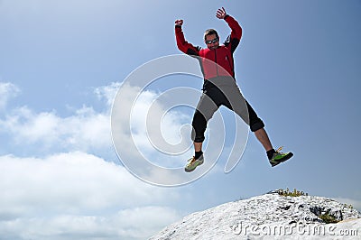 Brave man jumping from a cliff