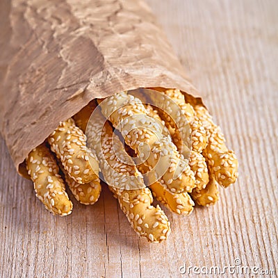 Bread sticks grissini with sesame seeds in craft pack