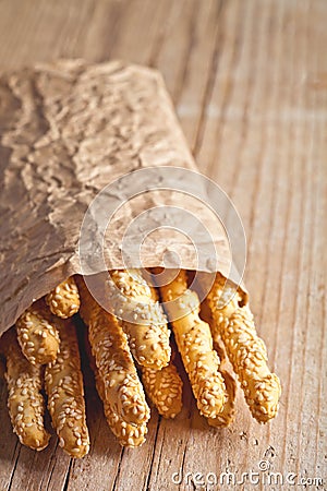 Bread sticks grissini with sesame seeds in craft pack